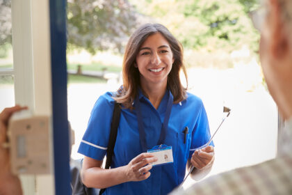 Nurse holding ID card at hospital entrance